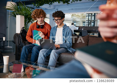 Two teenage boys talking in modern office Two teenage boys talking in modern office 116628089