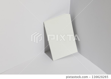 A blank book stands upright against a white background with copy space 116628265