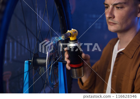 Arming up and aligning brake disc at bicycle garage service Arming up and aligning brake disc at bicycle garage service 116628346