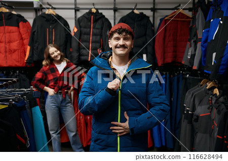 Portrait of satisfied smiling male client of sportive clothing store 116628494