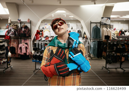 Cool hipster sportsman standing over sports clothing store interior 116628499