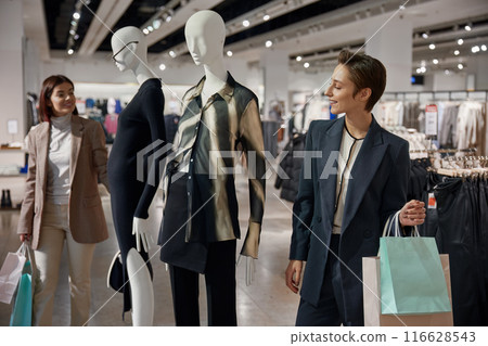 Two young elegant women friends engaged in shopping tourism 116628543