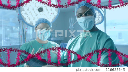 Surgeons in operating room, wearing masks and scrubs, preparing for surgery Surgeons in operating room, wearing masks and scrubs, preparing for surgery 116628645