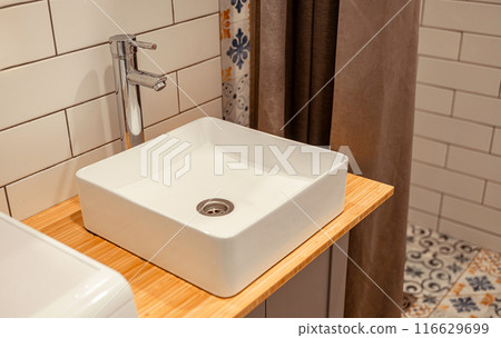 white rectangular sink and faucet in the bathroom white rectangular sink and faucet in the bathroom 116629699