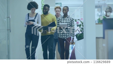 Diverse group of colleagues walking through office hallway 116629889
