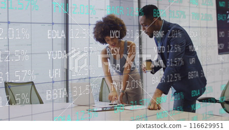 Image of trading board over diverse coworkers discussing reports on laptop and drinking coffee 116629951