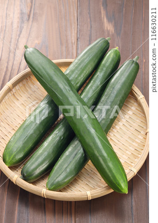 Fresh cucumbers in a colander Fresh cucumbers in a colander 116630211