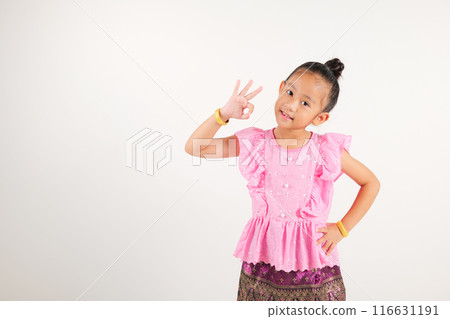 Portrait Thailand kid girl smiling traditional Thai dress costume showcases OK sign with smile, conveying agreement and positivity, studio isolated white background, kindergarten child success sign Portrait Thailand kid girl smiling traditional Thai dress costume showcases OK sign with smile, conveying agreement and positivity, studio isolated white background, kindergarten child success sign 116631191