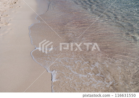 Spanish Beach with its pink and red sand and transparent water. Soft beautiful sea wave on sandy beach. Background. Spanish Beach with its pink and red sand and transparent water. Soft beautiful sea wave on sandy beach. Background. 116631550