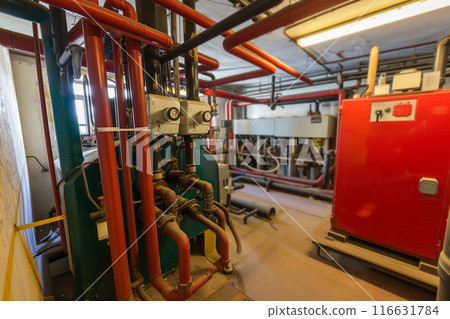 Modern gas boiler room with equipment for an autonomous heating system. Electric boiler room. Equipment for a modern heating system in the form of a boiler, heater, pipes, expansion tank and more. Modern gas boiler room with equipment for an autonomous heating system. Electric boiler room. Equipment for a modern heating system in the form of a boiler, heater, pipes, expansion tank and more. 116631784