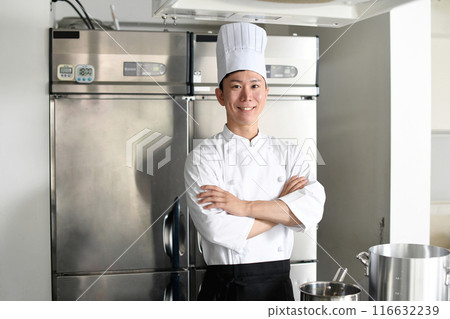 Young Asian male chef with arms crossed in the kitchen 116632239