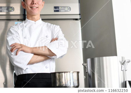 Young Asian male chef with arms crossed in the kitchen Young Asian male chef with arms crossed in the kitchen 116632250