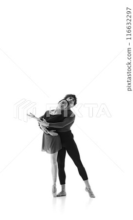 Poised man and woman, ballet partners enhancing their dance together against white studio background. Sepia filter. 116632297