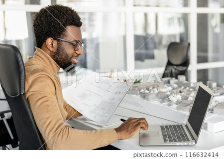 Talented man architect sketching plans in the office 116632414