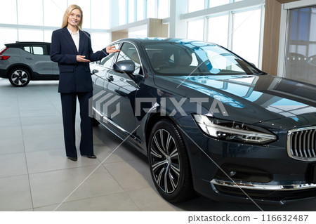Pretty blonde young woman working in a car showroom 116632487