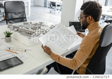 Skillful man architect using technology in his workplace Skillful man architect using technology in his workplace 116632727