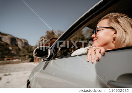 Woman in a White Car, Sunglasses on, Looking Out the Window Woman in a White Car, Sunglasses on, Looking Out the Window 116632985