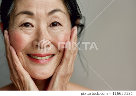Portrait of a senior middle-aged woman with her hand on her cheek (beauty, plastic surgery, anti-aging) 116633185