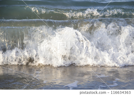 Beautiful seascape with sea waves and sand. Sea waves on the beach. 116634363