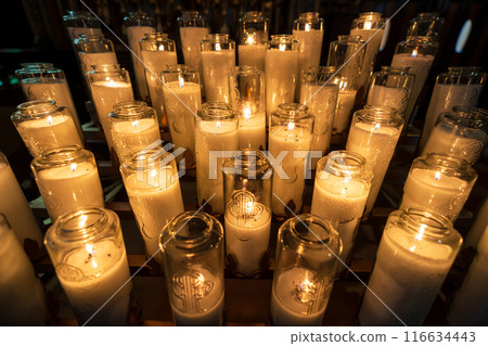 Rows of white lit votive candles or prayer candles in church. Notre-Dame Basilica. Montreal, Quebec, Canada. Rows of white lit votive candles or prayer candles in church. Notre-Dame Basilica. Montreal, Quebec, Canada. 116634443
