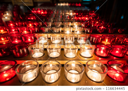 Rows of red and white lit votive candles or prayer candles in church. Notre-Dame Basilica. Montreal, Quebec, Canada. Rows of red and white lit votive candles or prayer candles in church. Notre-Dame Basilica. Montreal, Quebec, Canada. 116634445