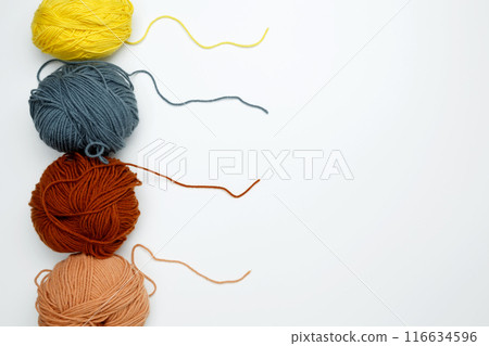 Color yarn for knitting, white background. Top view. Copy space, flat lay Color yarn for knitting, white background. Top view. Copy space, flat lay 116634596