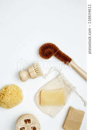 Natural organic eco cosmetics. Soap Eco, reusable cotton pads, loofah natural sponge washcloth, cotton swab, eucalyptus leaves on white background. Flat lay, top view, copy space Natural organic eco cosmetics. Soap Eco, reusable cotton pads, loofah natural sponge washcloth, cotton swab, eucalyptus leaves on white background. Flat lay, top view, copy space 116634611