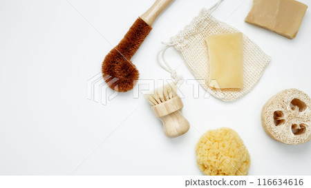 Natural organic eco cosmetics. Soap Eco, reusable cotton pads, loofah natural sponge washcloth, cotton swab, eucalyptus leaves on white background. Flat lay, top view, copy space Natural organic eco cosmetics. Soap Eco, reusable cotton pads, loofah natural sponge washcloth, cotton swab, eucalyptus leaves on white background. Flat lay, top view, copy space 116634616