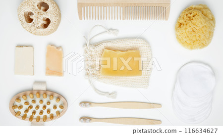 Natural organic eco cosmetics. Soap Eco, reusable cotton pads, loofah natural sponge washcloth, cotton swab, eucalyptus leaves on white background. Flat lay, top view Natural organic eco cosmetics. Soap Eco, reusable cotton pads, loofah natural sponge washcloth, cotton swab, eucalyptus leaves on white background. Flat lay, top view 116634627