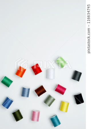 Multicolored sewing threads on white background. Top view, copy space 116634745