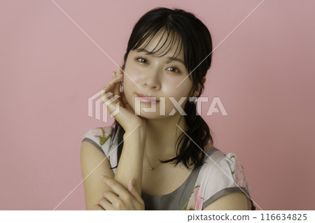 Portrait of a young woman on a pink background Portrait of a young woman on a pink background 116634825