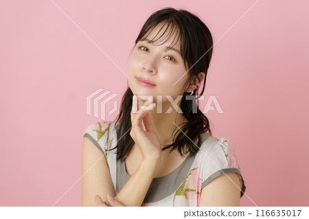 Portrait of a young woman on a pink background 116635017