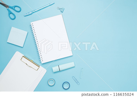 Creative flat lay mockup design of workspace. Top view composition with white notebook, to do list and stationery on blue background Creative flat lay mockup design of workspace. Top view composition with white notebook, to do list and stationery on blue background 116635024