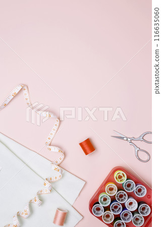 Composition with various threads and sewing accessories on pink background. Top view, copy space 116635060