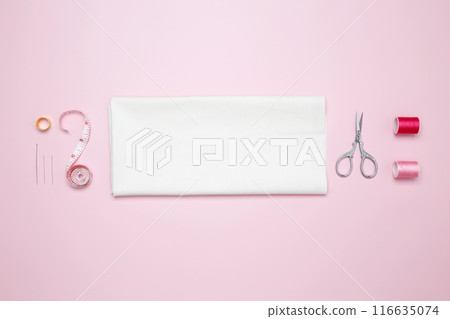 Composition with various threads and sewing accessories on pink background. Top view, copy space 116635074