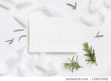 Horizontal Blank card near white silk ribbons and rosemary leaves top view, wedding mockup Horizontal Blank card near white silk ribbons and rosemary leaves top view, wedding mockup 116635082