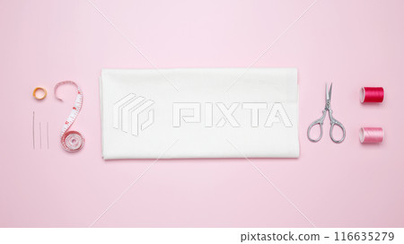 Composition with various threads and sewing accessories on pink background. Top view, copy space 116635279