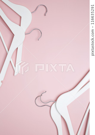 Creative flat lay hangers pink background. Sale discount store promo shopping concept. Top view. Copy space 116635291