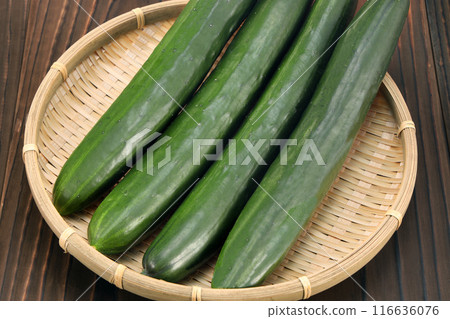 Fresh cucumbers in a colander 116636076