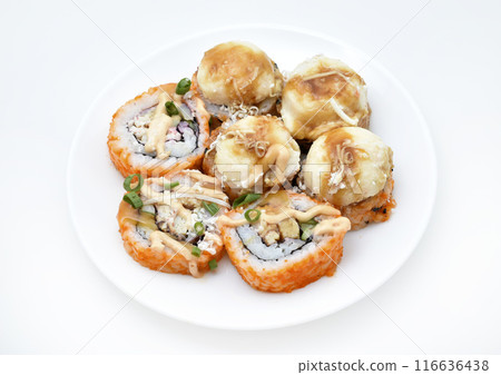 Fish rolls on a white plate.  Rice snack. 116636438