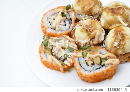 Fish rolls on a white plate.  Rice snack. 116636443