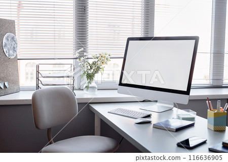 Still life shot of mockup screen of computer on desk in empty office or classroom next to window Still life shot of mockup screen of computer on desk in empty office or classroom next to window 116636905