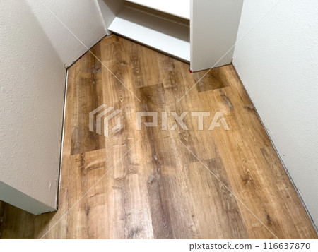 Broomfield, Colorado, USA-July 6, 2024-A view of newly installed laminate flooring in a small closet. The wooden planks are neatly aligned, showcasing a smooth and polished finish. The closet features 116637870