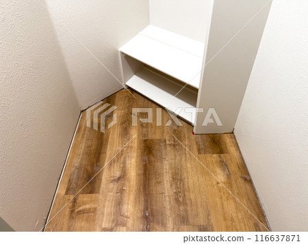Broomfield, Colorado, USA-July 6, 2024-A view of newly installed laminate flooring in a small closet. The wooden planks are neatly aligned, showcasing a smooth and polished finish. The closet features 116637871