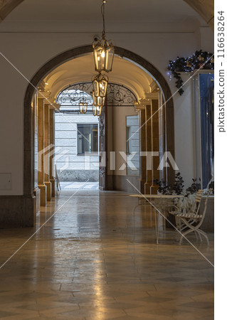 View of Arches corridor with Antique lantern hanging from ceiling in Ancient building. View of Arches corridor with Antique lantern hanging from ceiling in Ancient building. 116638264
