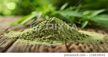 Close Up of Green Hemp Powder on Wooden Surface With Leaves in Background Close Up of Green Hemp Powder on Wooden Surface With Leaves in Background 116639042