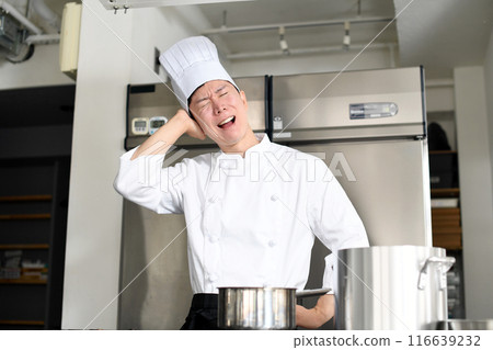 Worried young Asian female cook holding a pot 116639232