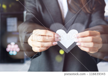 Woman in business suit holding a paper heart . 116639343