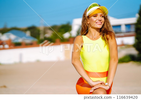 Three young woman in bright swimsuits dancing. Sport, summer, fitness, urban culture concept. Three young woman in bright swimsuits dancing. Sport, summer, fitness, urban culture concept. 116639420