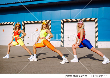 Three young woman in bright swimsuits dancing. Sport, summer, fitness, urban culture concept. 116639436